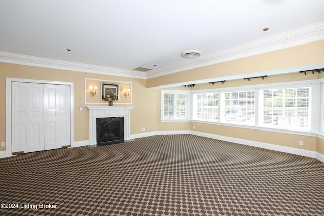 unfurnished living room with carpet, crown molding, and a high end fireplace