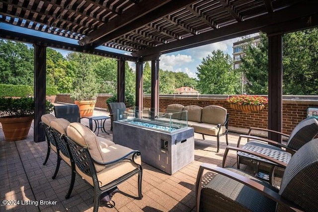 view of patio / terrace with a pergola and an outdoor living space with a fire pit