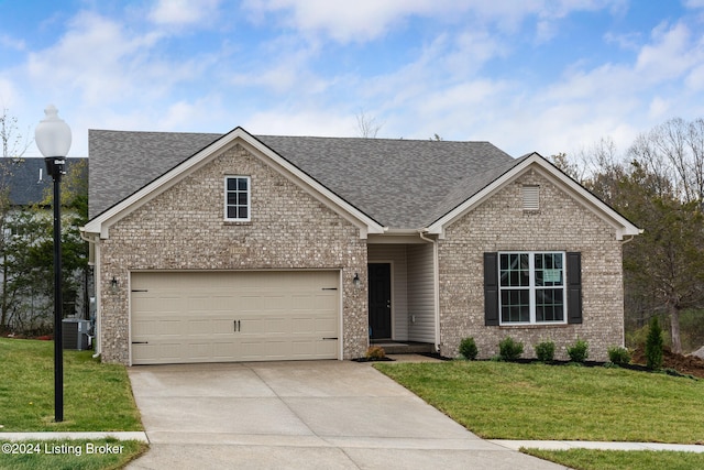 view of front facade with cooling unit, a front lawn, and a garage