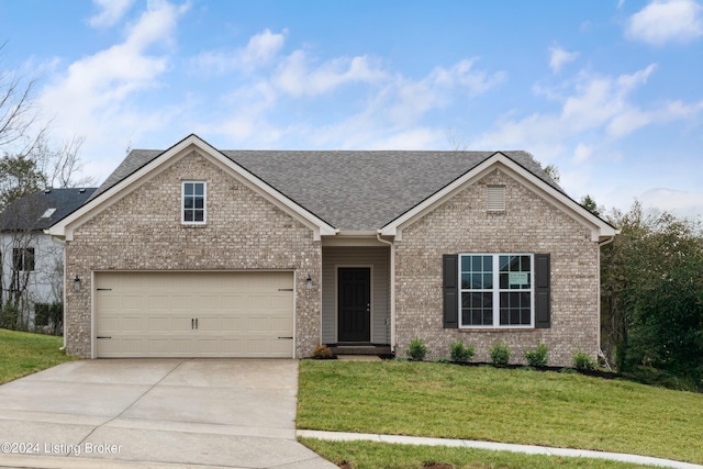 view of front of home featuring a front yard and a garage