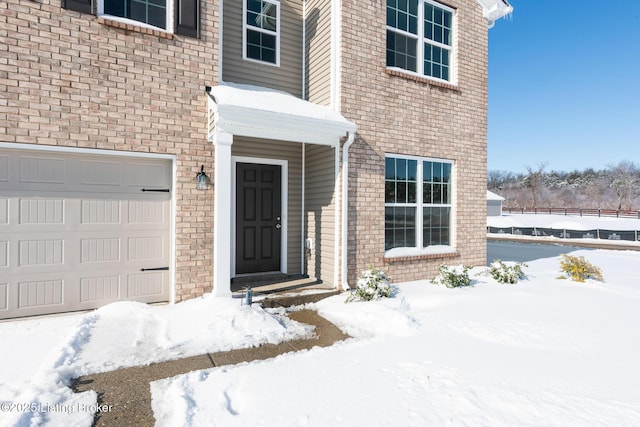 view of snow covered property entrance