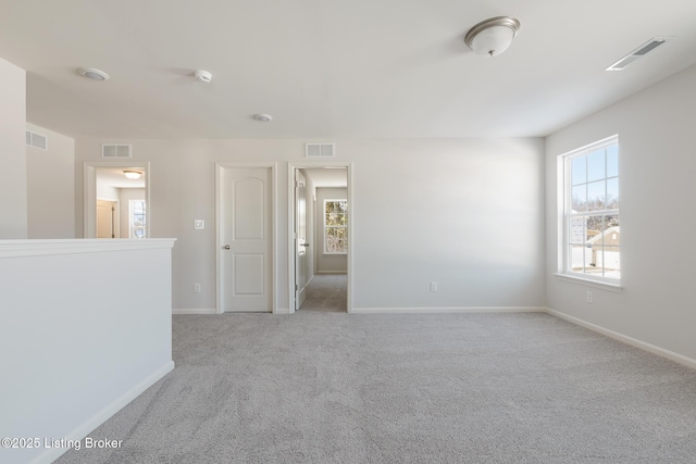 unfurnished room with light carpet