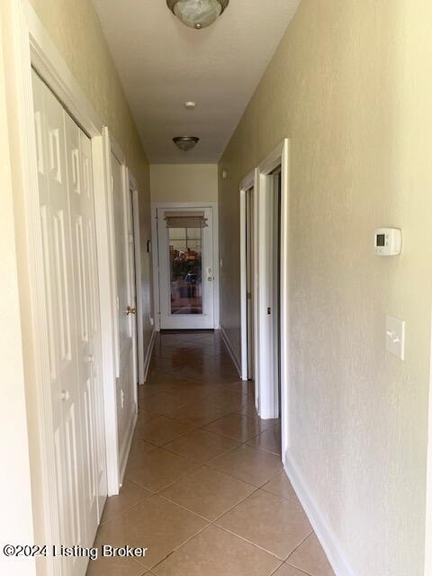 hall with tile patterned flooring