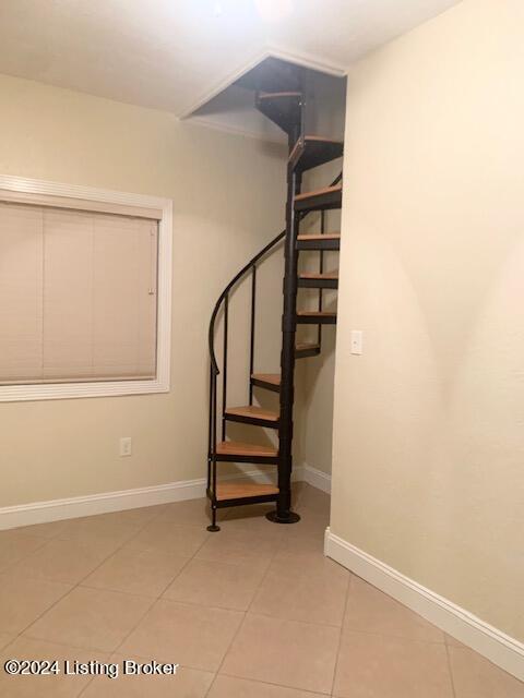 stairway featuring tile patterned flooring