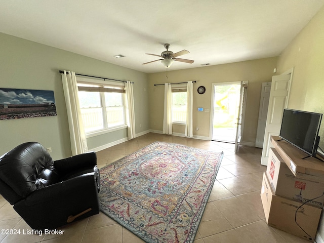 living room featuring ceiling fan and light tile patterned flooring