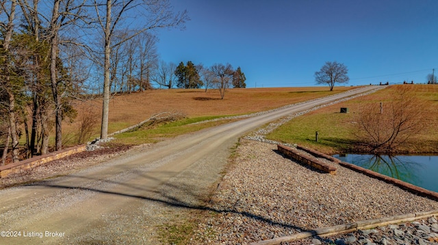 view of street featuring a water view and a rural view