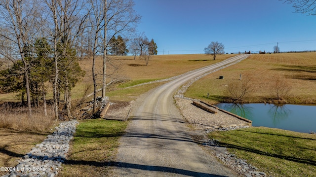 view of street featuring a water view and a rural view