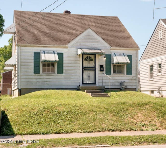 bungalow-style house with a front yard