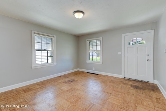 entryway with light parquet flooring