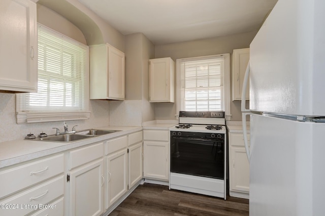 kitchen featuring plenty of natural light, white cabinets, and white appliances