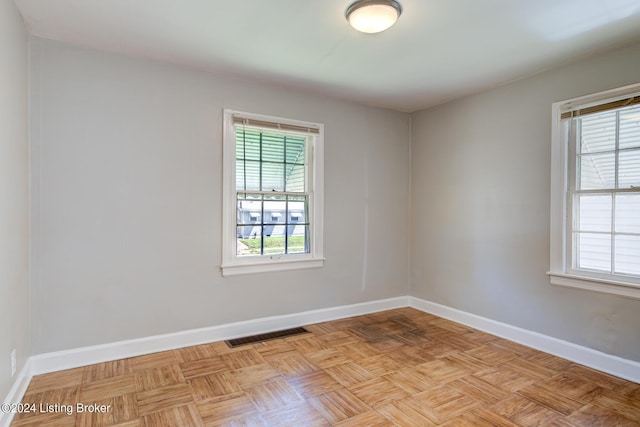 unfurnished room featuring light parquet flooring