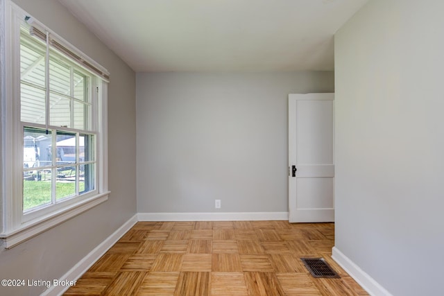 empty room with light parquet flooring