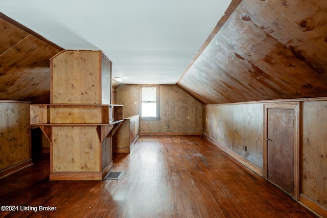 bonus room with dark hardwood / wood-style floors and lofted ceiling