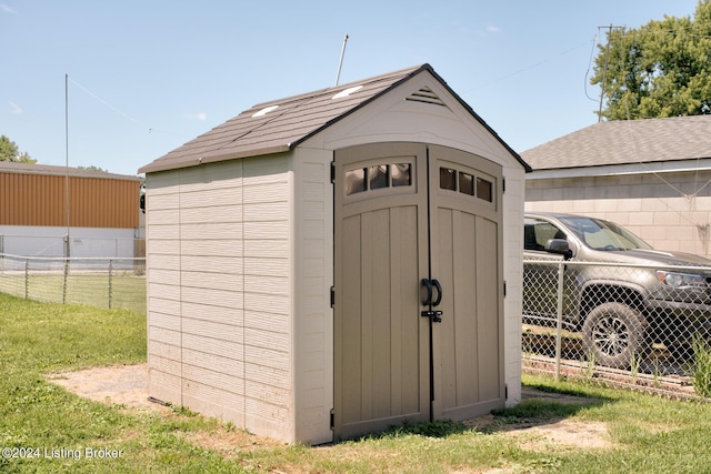 view of outdoor structure featuring a lawn