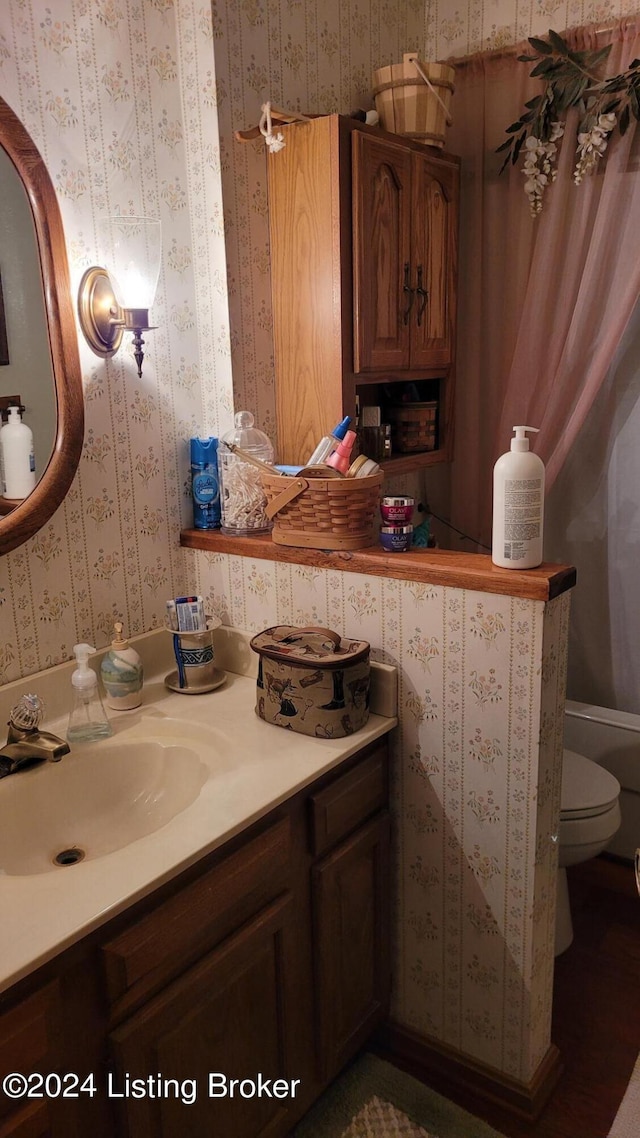 bathroom featuring vanity and toilet