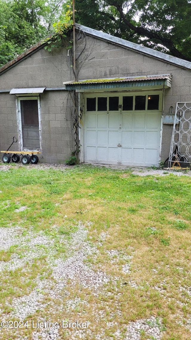 garage featuring a lawn