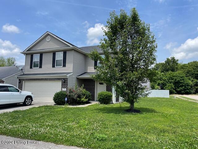 view of front of home featuring a garage and a front yard