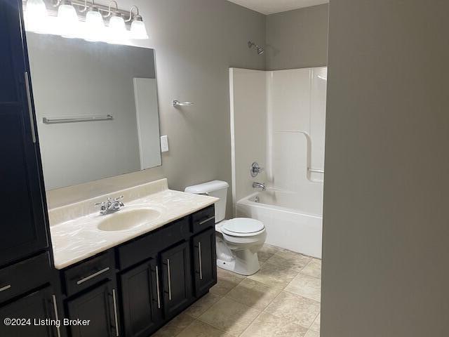 full bathroom featuring shower / washtub combination, vanity, and toilet