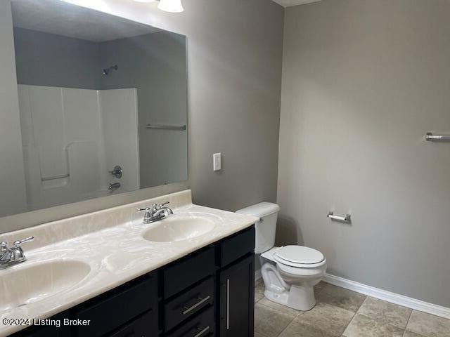 full bathroom with shower / bathtub combination, vanity, toilet, and tile patterned flooring