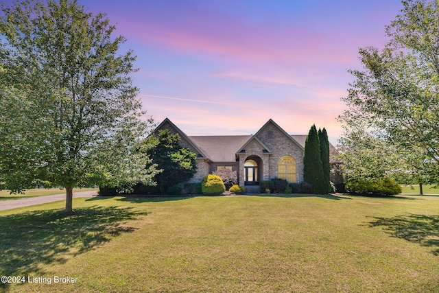 french country style house with a yard