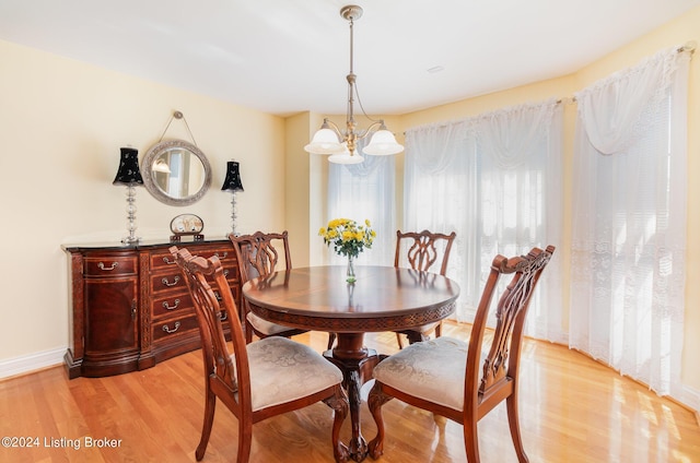 dining room with an inviting chandelier and light wood-type flooring