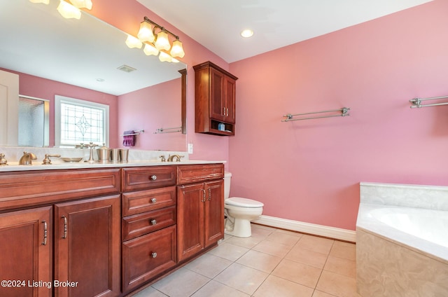 bathroom with vanity, a tub, tile patterned floors, and toilet