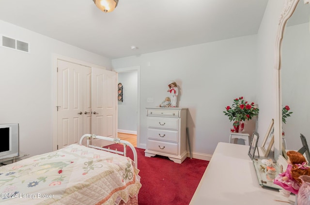 carpeted bedroom with a closet