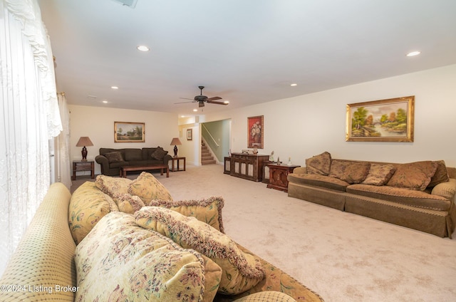 carpeted living room with ceiling fan