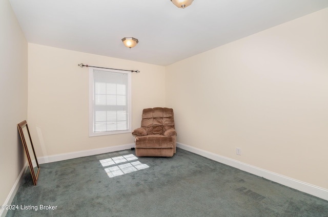 unfurnished room featuring dark colored carpet