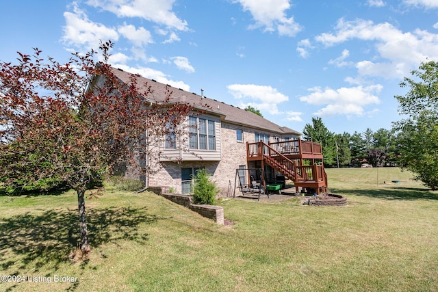 back of property featuring a lawn and a deck