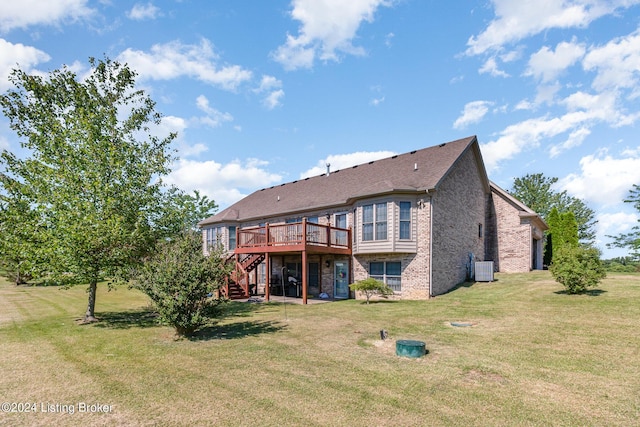 rear view of property featuring central AC unit, a yard, and a deck