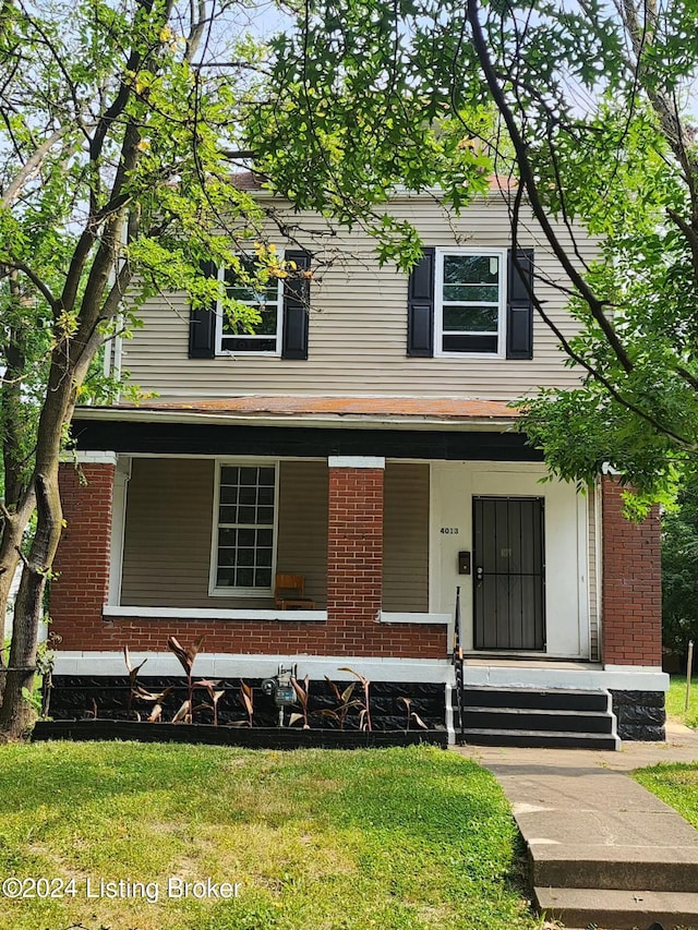 view of front of home featuring covered porch and a front yard