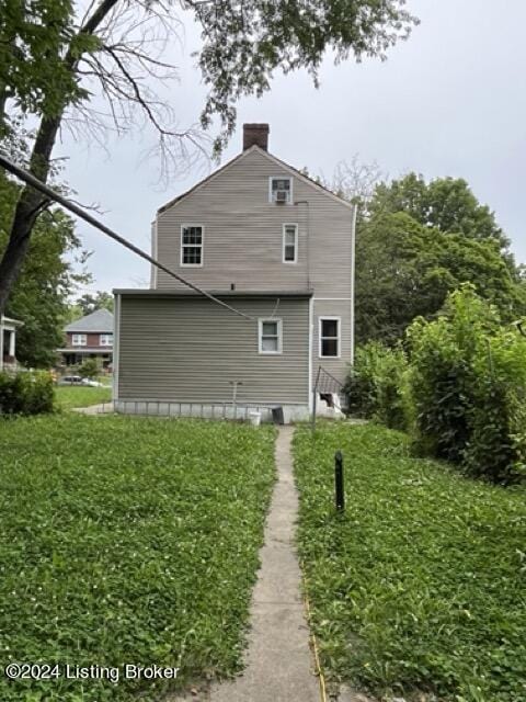 view of side of home featuring a lawn