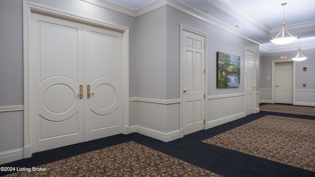 entryway featuring crown molding and dark colored carpet