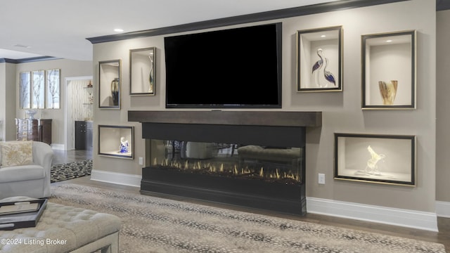 living room with a multi sided fireplace, crown molding, and wood-type flooring