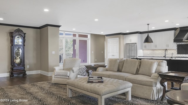 living room with ornamental molding, dark wood-type flooring, and sink