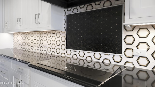 kitchen featuring tasteful backsplash and white cabinetry