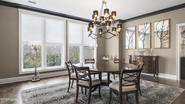 dining area featuring a notable chandelier, dark hardwood / wood-style floors, and crown molding