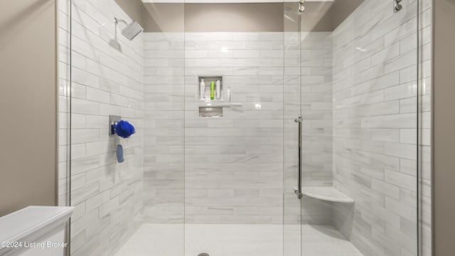 bathroom with an enclosed shower and toilet