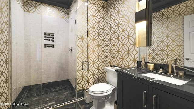 bathroom featuring a tile shower, vanity, and toilet