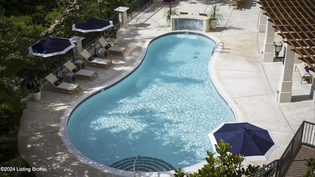 view of pool with pool water feature and a patio