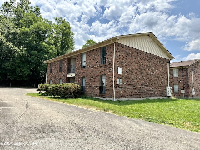 view of property exterior with a yard