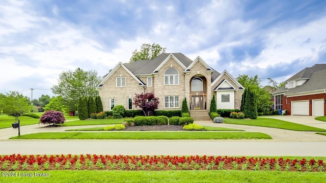 view of front of house with a garage, driveway, and a front lawn