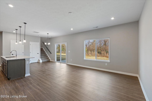 interior space featuring dark wood-type flooring, sink, and an inviting chandelier