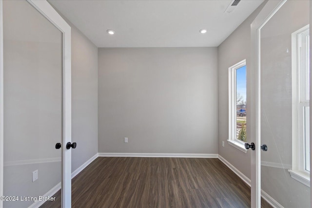 spare room featuring dark hardwood / wood-style flooring