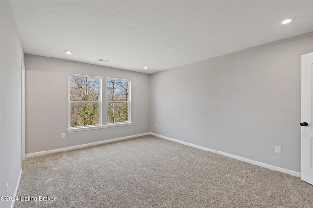 unfurnished room featuring carpet