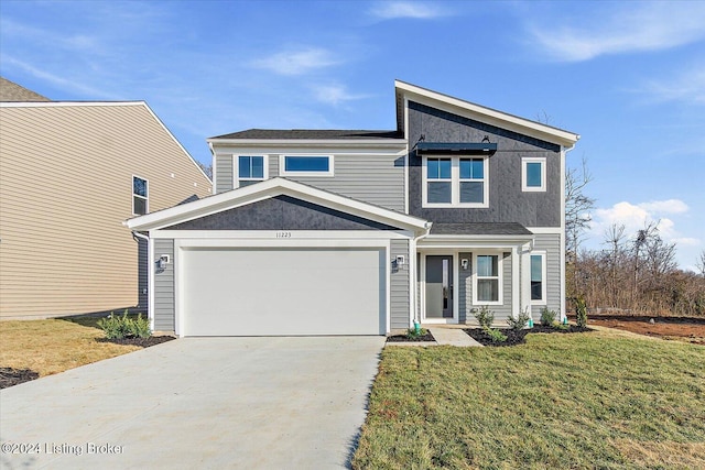 view of front of home with a garage and a front lawn