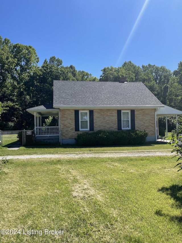 view of front of property with covered porch and a front lawn