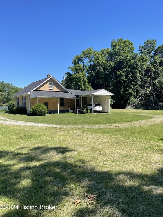 view of front facade with a carport and a front lawn