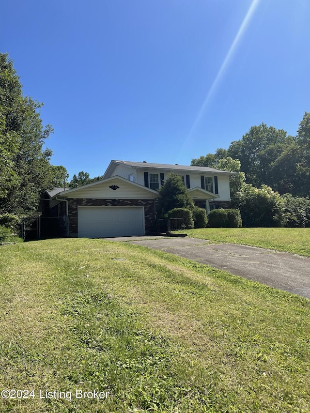 view of front of house with a garage and a front yard